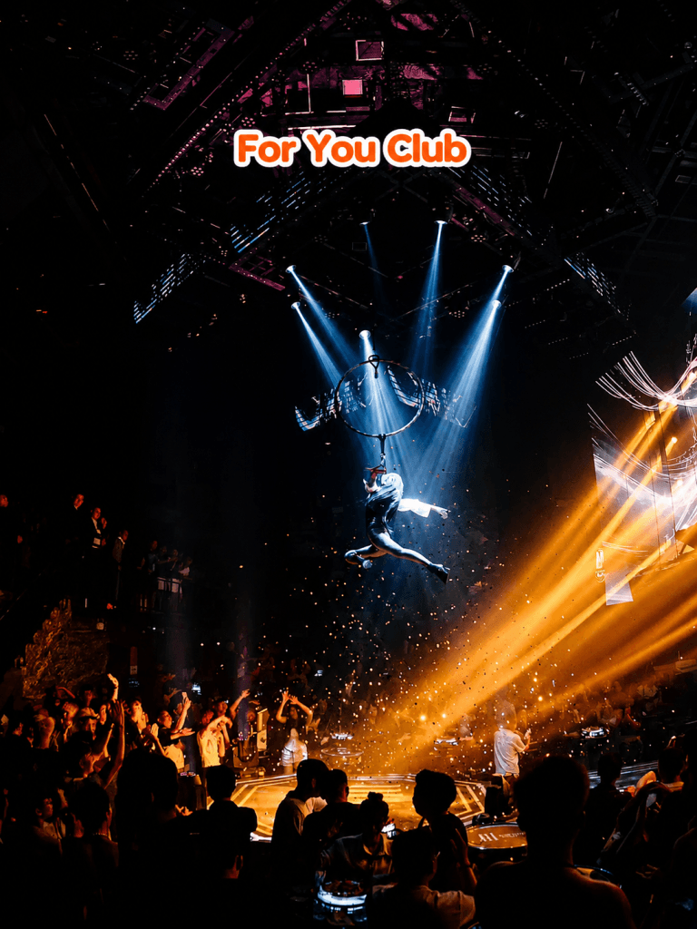 An aerial performer above the crowd under spotlights at 4U Club (For You Club) in Da Nang