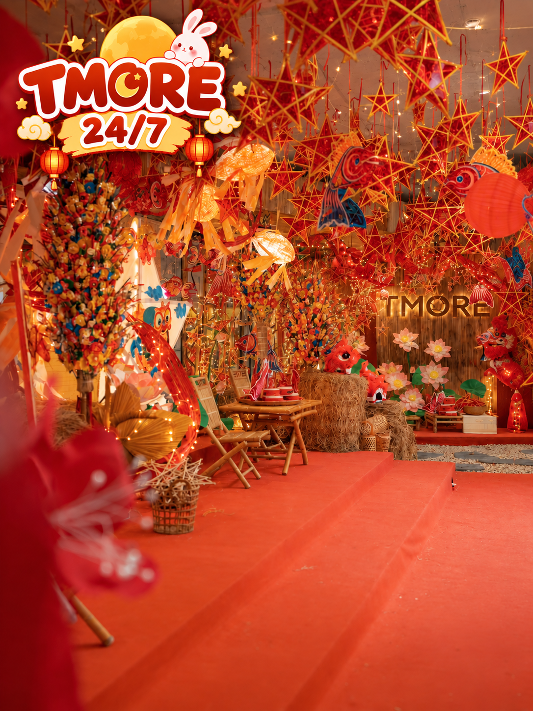 Hundreds of red star lanterns and carp lanterns hanging over a bamboo seating area at TMORE 24/7 café in Da Nang for the Mid-Autumn Festival