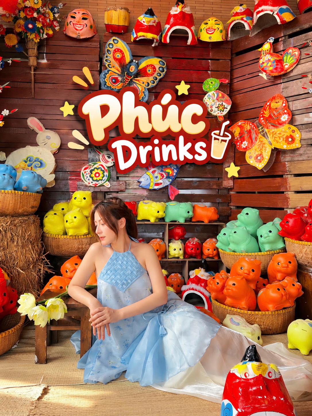 Woman in a blue dress surrounded by traditional Mid-Autumn toys, papier-mâché masks, lanterns and colorful clay piggy banks at Phúc Drinks, Da Nang