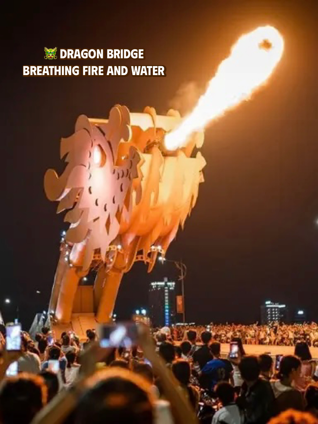 The Dragon Bridge in Da Nang breathing fire at night as crowds watch and take photos