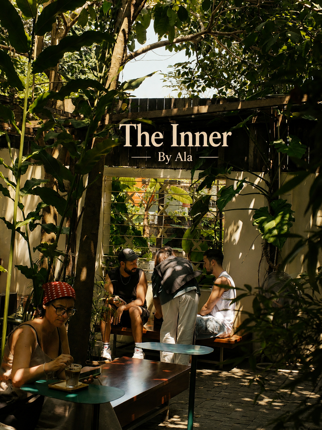 The Inner by Ala cafe in Hoi An, a leafy garden courtyard with guests at tables