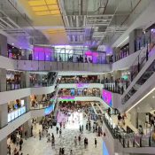 Inside AEON Mall Da Nang Thanh Khe: four floors of shops around a bright central atrium with escalators and shoppers below