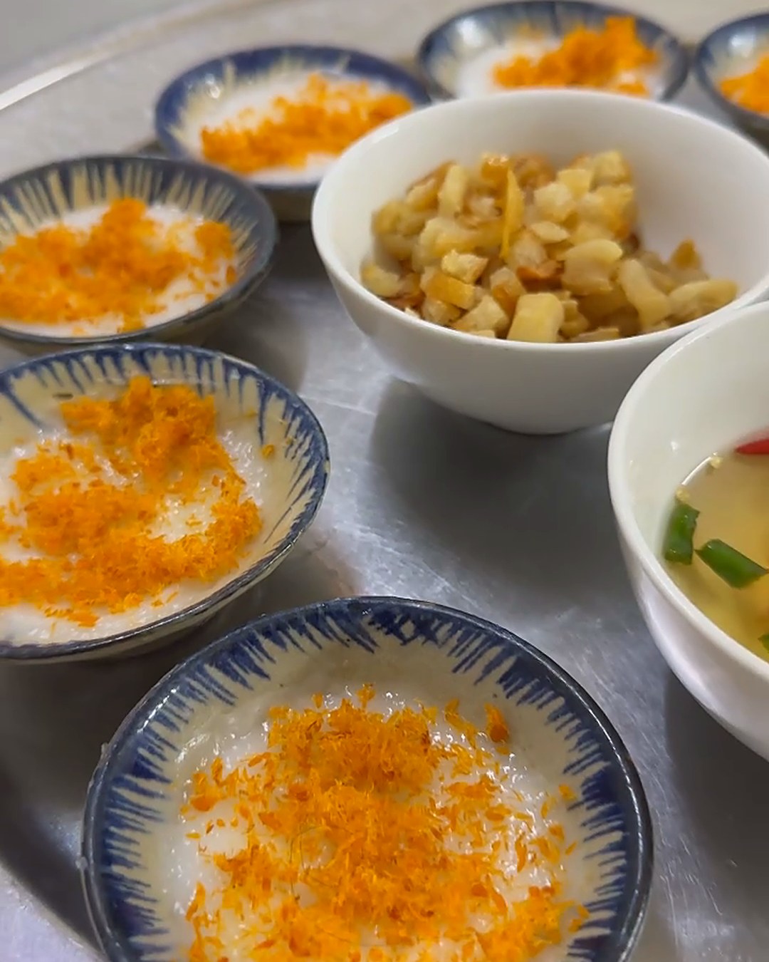 Close-up of soft, thick bánh bèo bọt biển topped with cá chấy fish floss