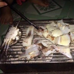 Grilling our catch, squid and crab, at Bãi Hương