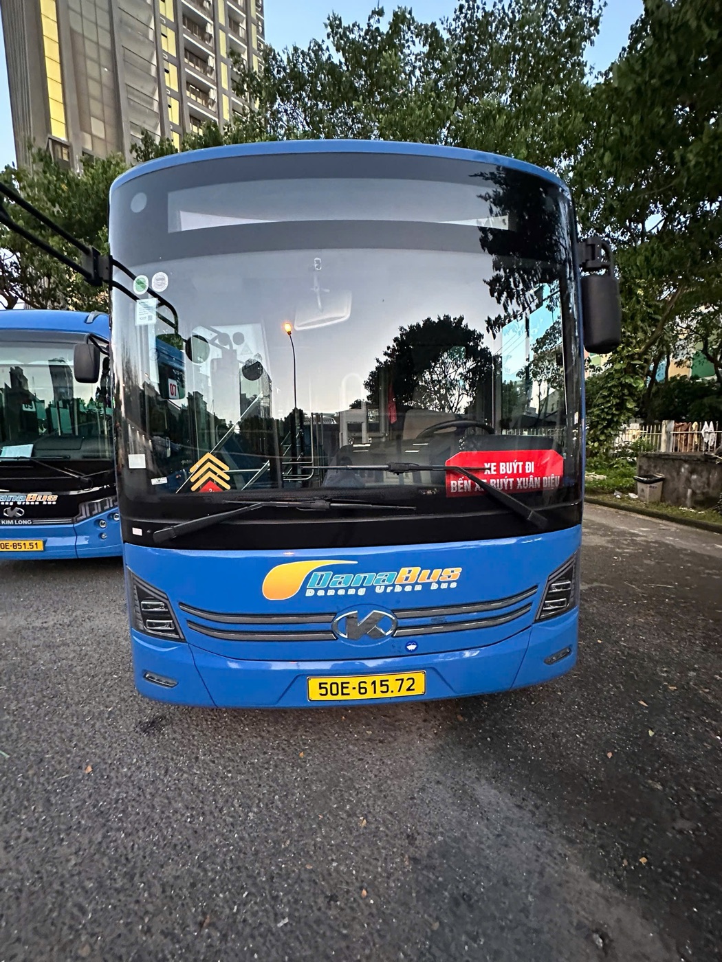 Front of a blue DanaBus electric city bus parked at a bus station in Da Nang