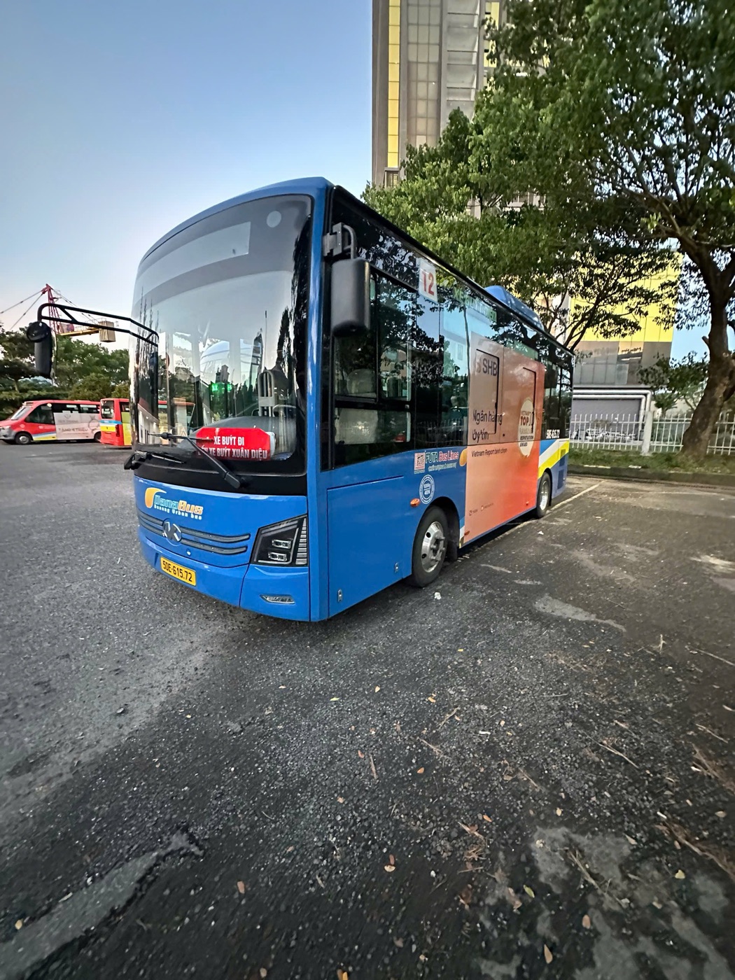 Blue DanaBus route 12 electric bus parked at the bus station on Xuân Diệu street, Da Nang