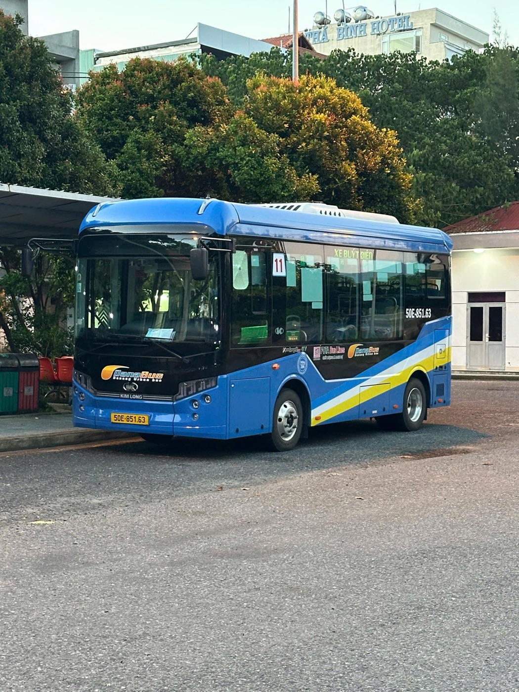 Blue Kim Long electric bus on DanaBus route 11 parked at a bus station in Da Nang