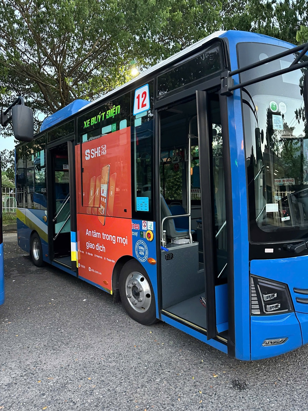 Open front door of a DanaBus route 12 electric bus in Da Nang