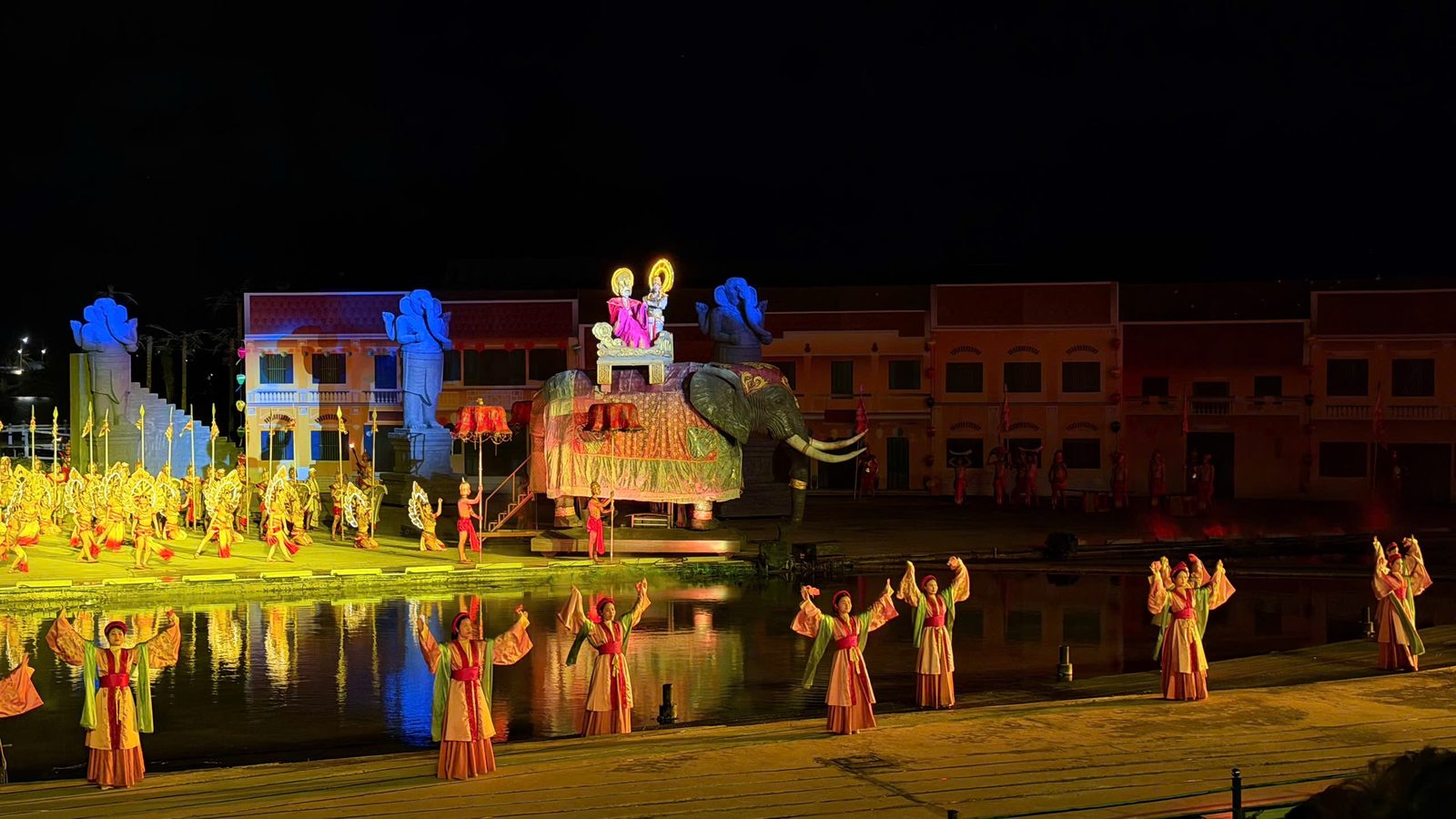 The royal wedding act of the Hoi An Memories show: the princess and the Cham king ride a decorated elephant across the river stage while dancers in red and gold perform in front