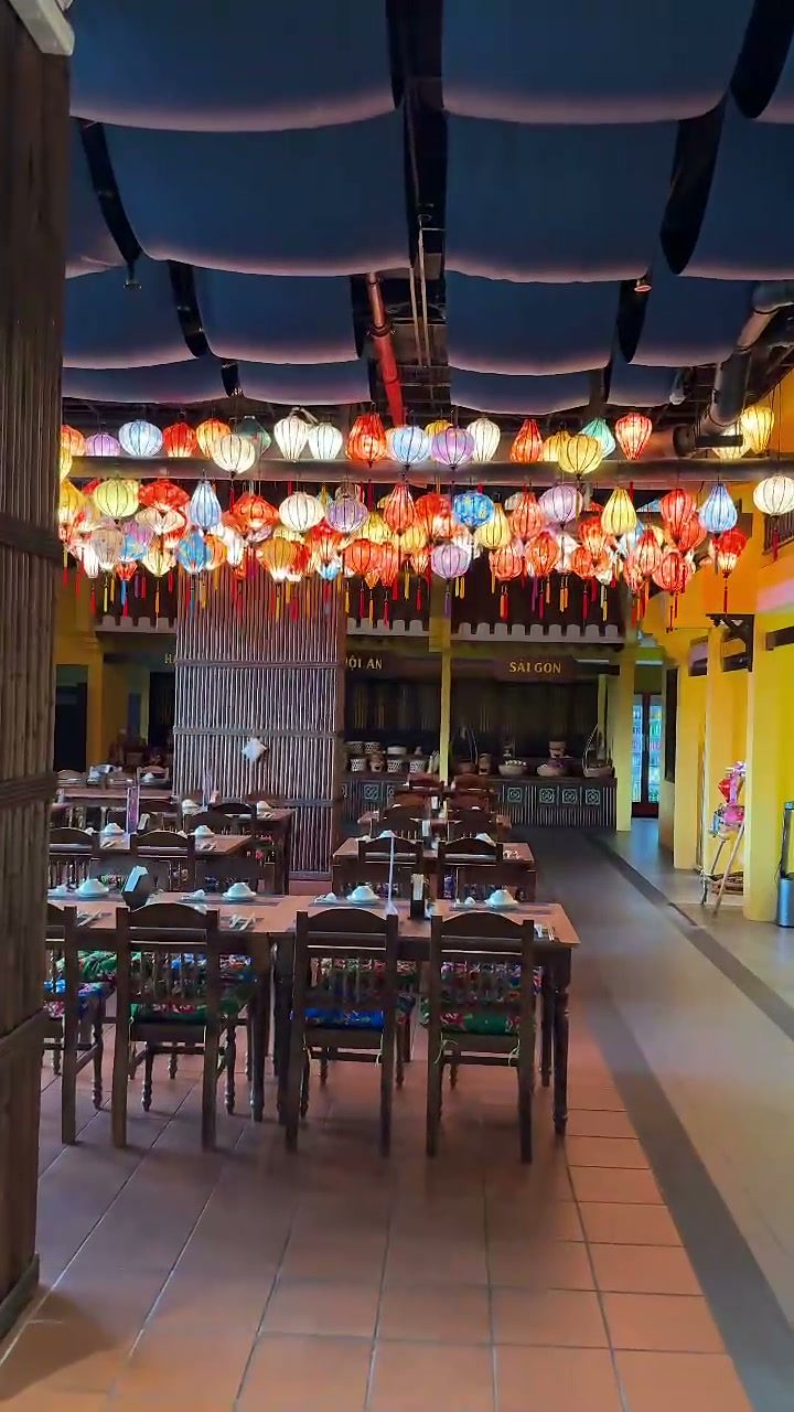 Vietnamese restaurant dining room under a ceiling of colourful silk lanterns at Hoiana Resort & Golf