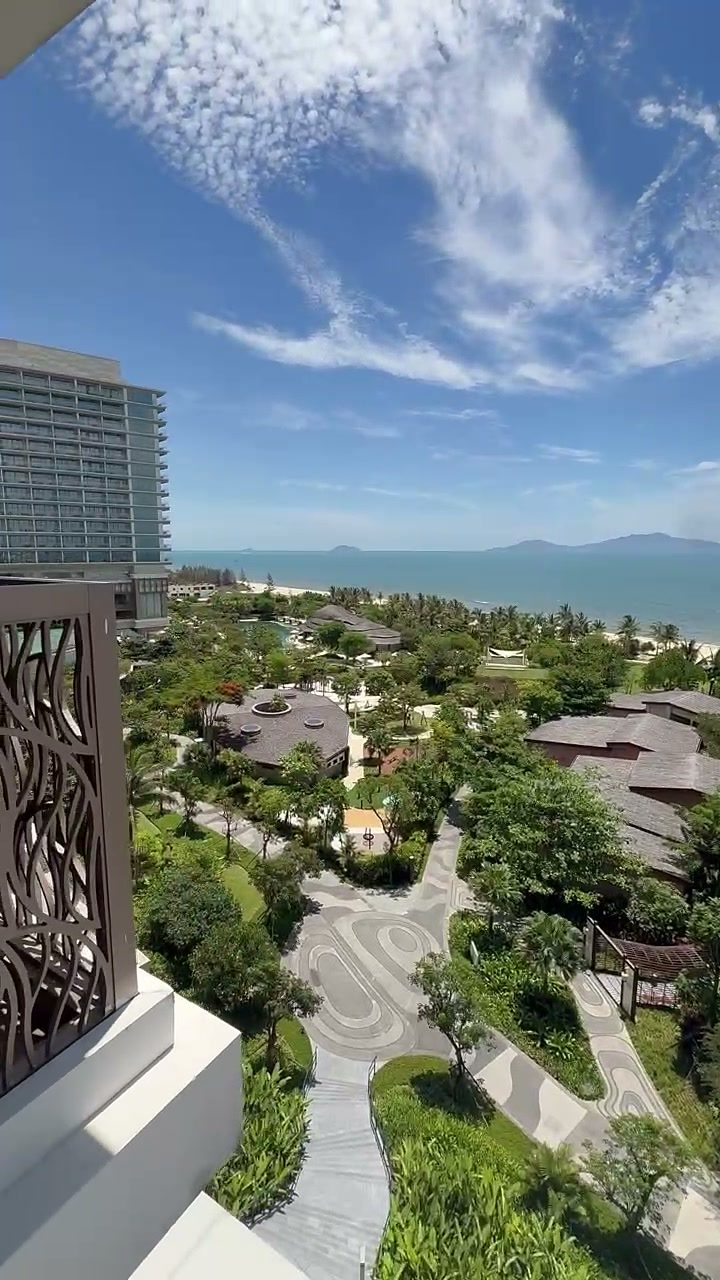 Suite balcony view over resort villas, gardens and the sea at Hoiana Resort & Golf