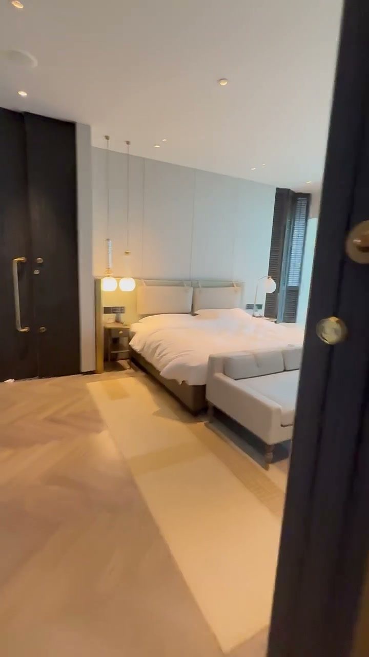 Suite bedroom with a large bed and soft lighting at Hoiana Resort & Golf