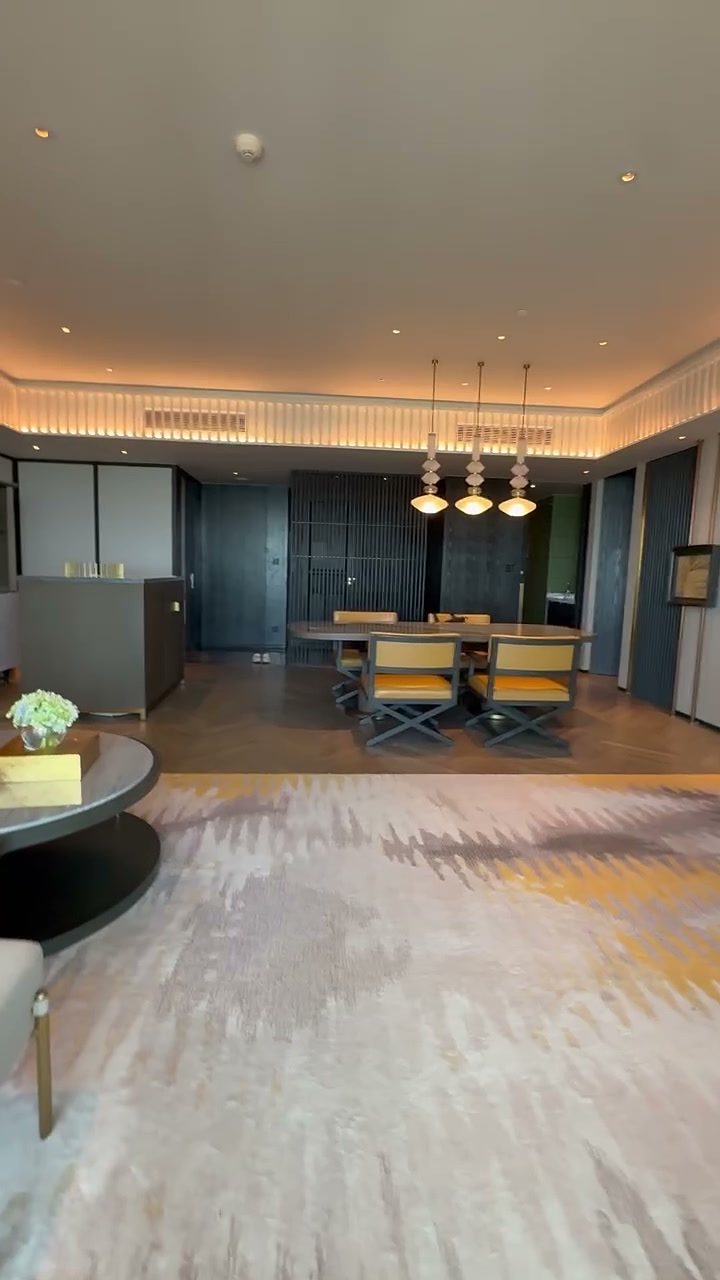 Suite dining table under pendant lights in a spacious living area at Hoiana Resort & Golf