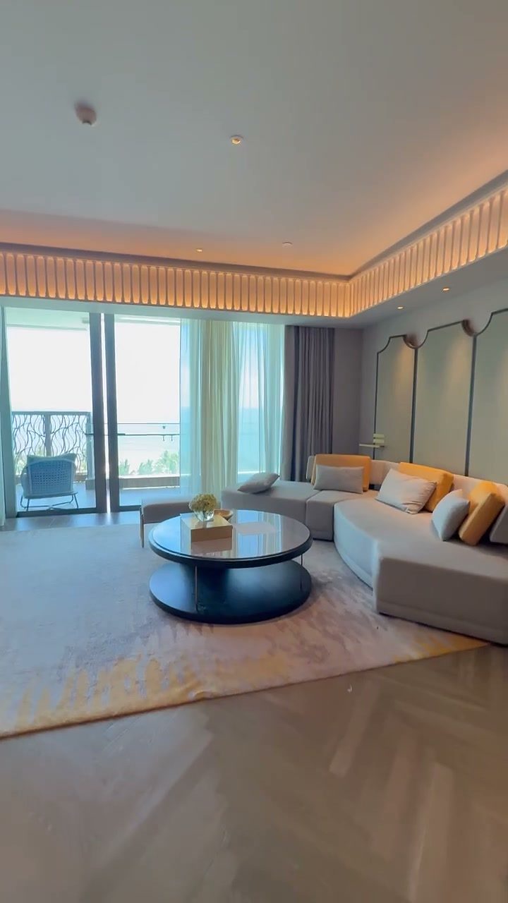 Sea-view suite living room with a sofa and round coffee table at Hoiana Resort & Golf