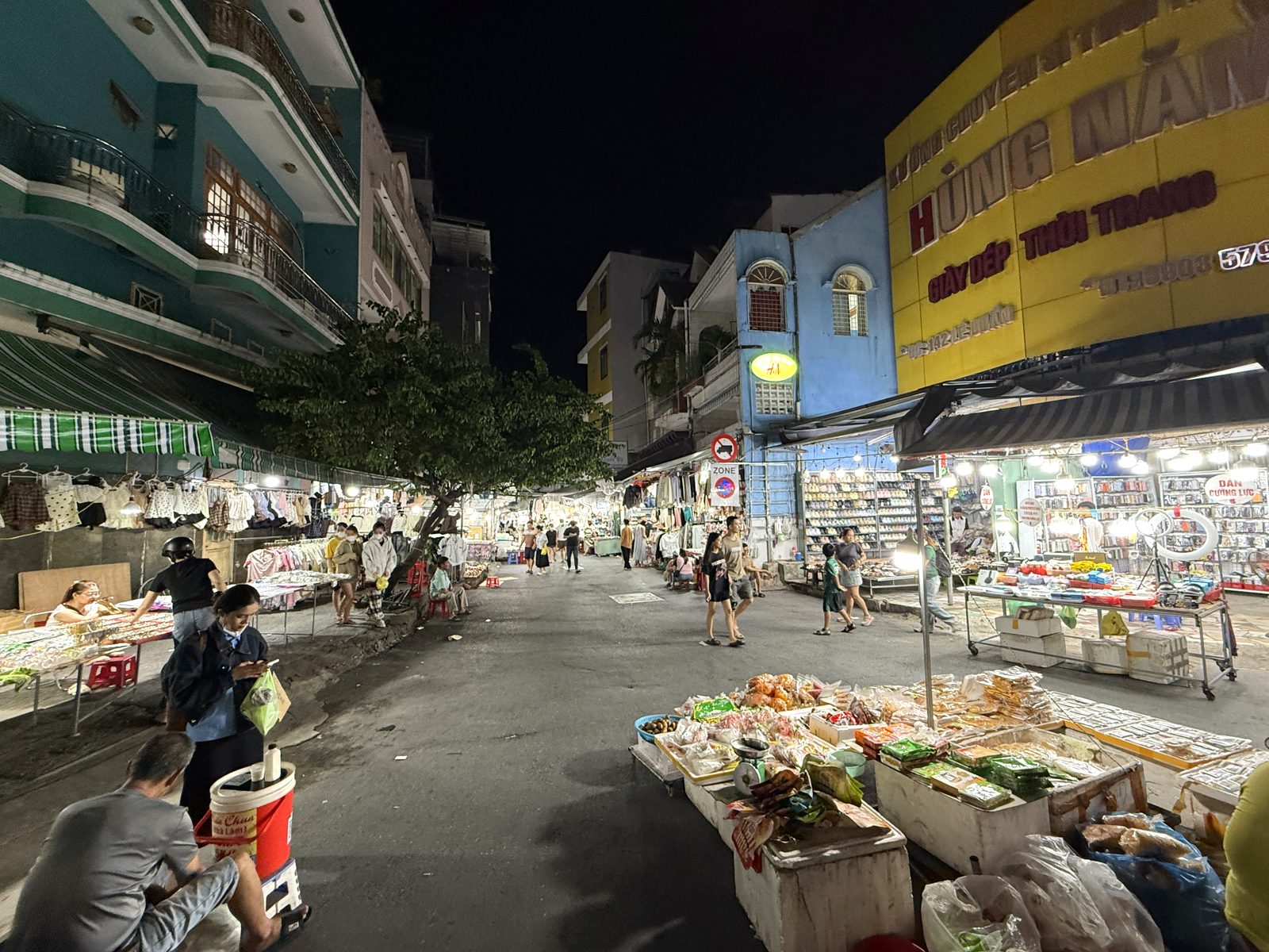 Night market stalls spreading out at the end of the alley at Le Duan Night Market, Da Nang
