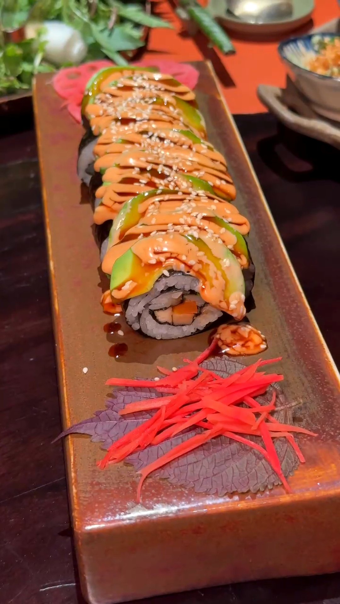 Avocado sushi roll (sushi bơ) on a wooden board at Maha Vegetariano Da Nang