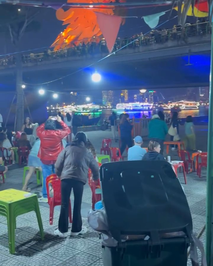 The glowing Dragon Bridge seen from Son Tra Night Market at night