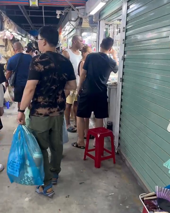 A busy covered aisle of stalls at Son Tra Night Market