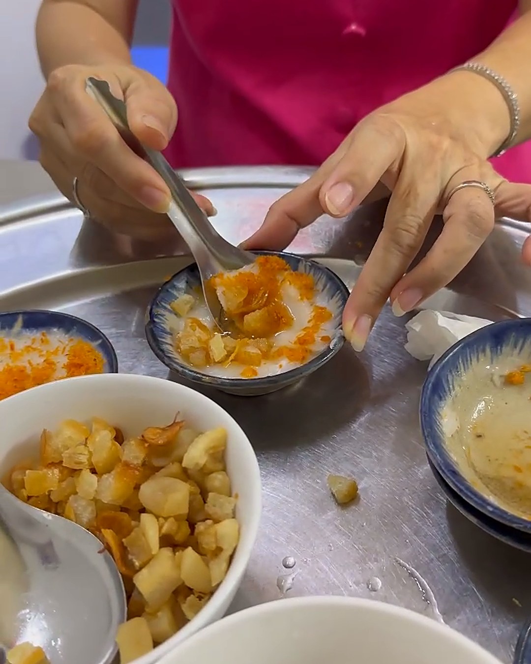 Spooning a soft bánh bèo out of its little dish in Da Nang