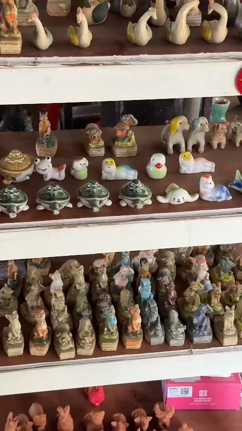 Shelves of small clay animals and whistles at a shop in Thanh Ha Pottery Village, Hoi An