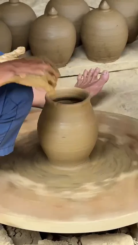 Clay pot taking shape on a spinning potter's wheel at Thanh Ha Pottery Village, Hoi An